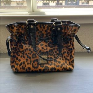 Leopard print Dooney & Bourke bag. Measures 11” by 9”.